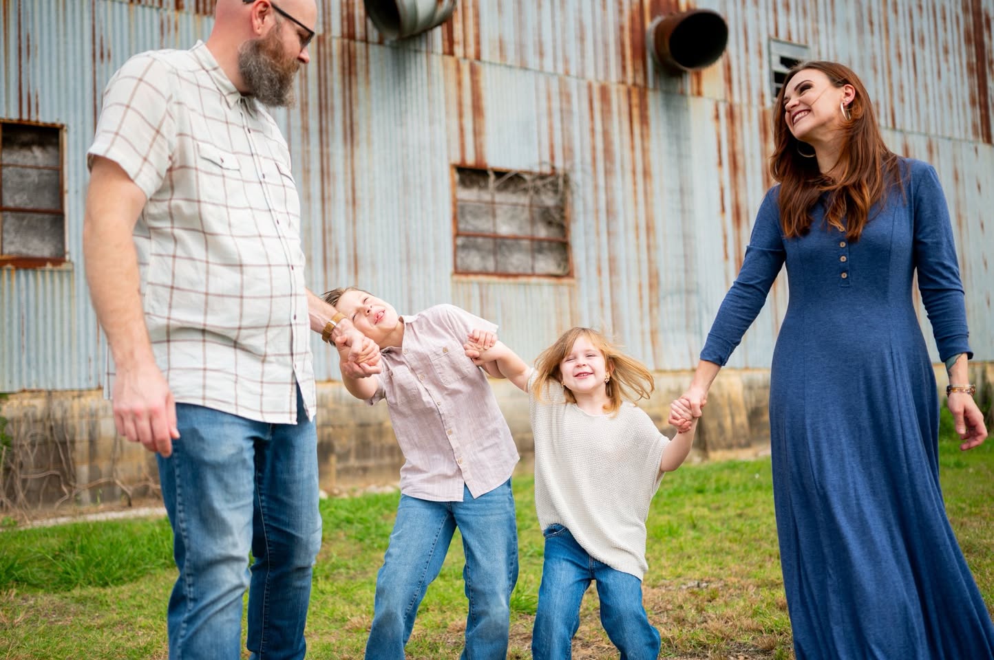 Family laughing and holding hands during a candid moment