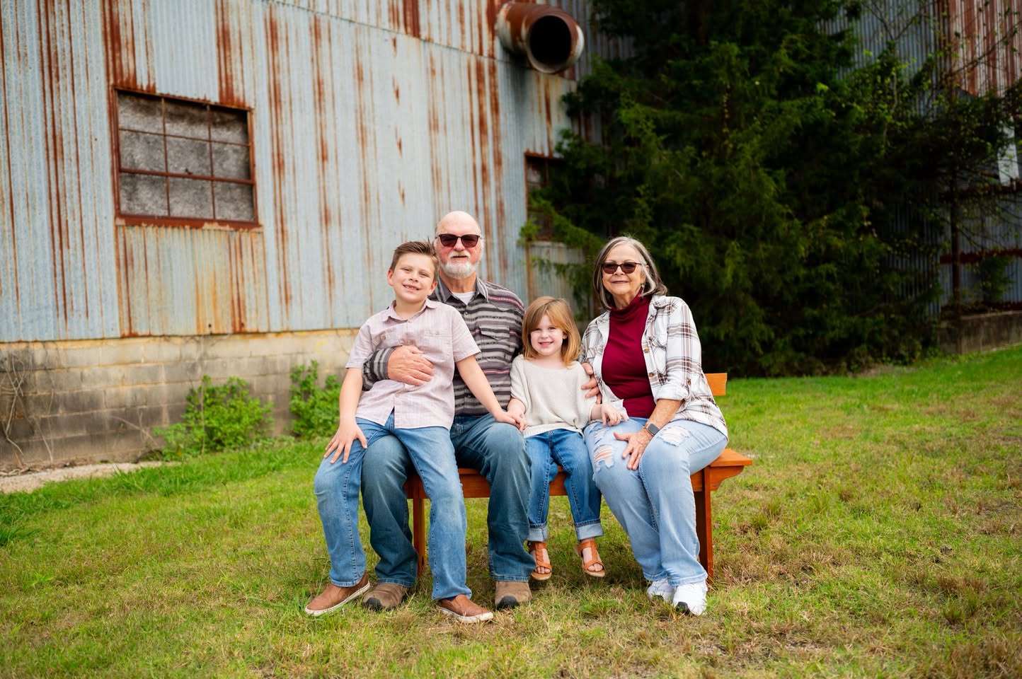 Grandparents seated with two grandchildren outdoors