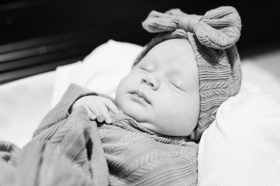 Sleeping newborn wearing a textured bow