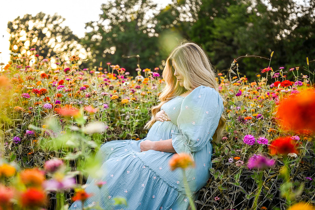 Expecting mother in a colorful flower field